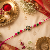 Rani Pink Thread, Pearl, Green And Rani Pink Beads With Square Meenakari Kundan Rakhi